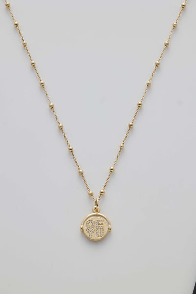 Gold necklace with spheres and a diamond-set spinner pendant revealing "I Love You" when spun.