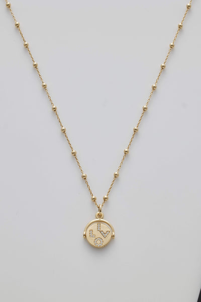 Gold necklace with spheres and a diamond-set spinner pendant revealing "I Love You" when spun.