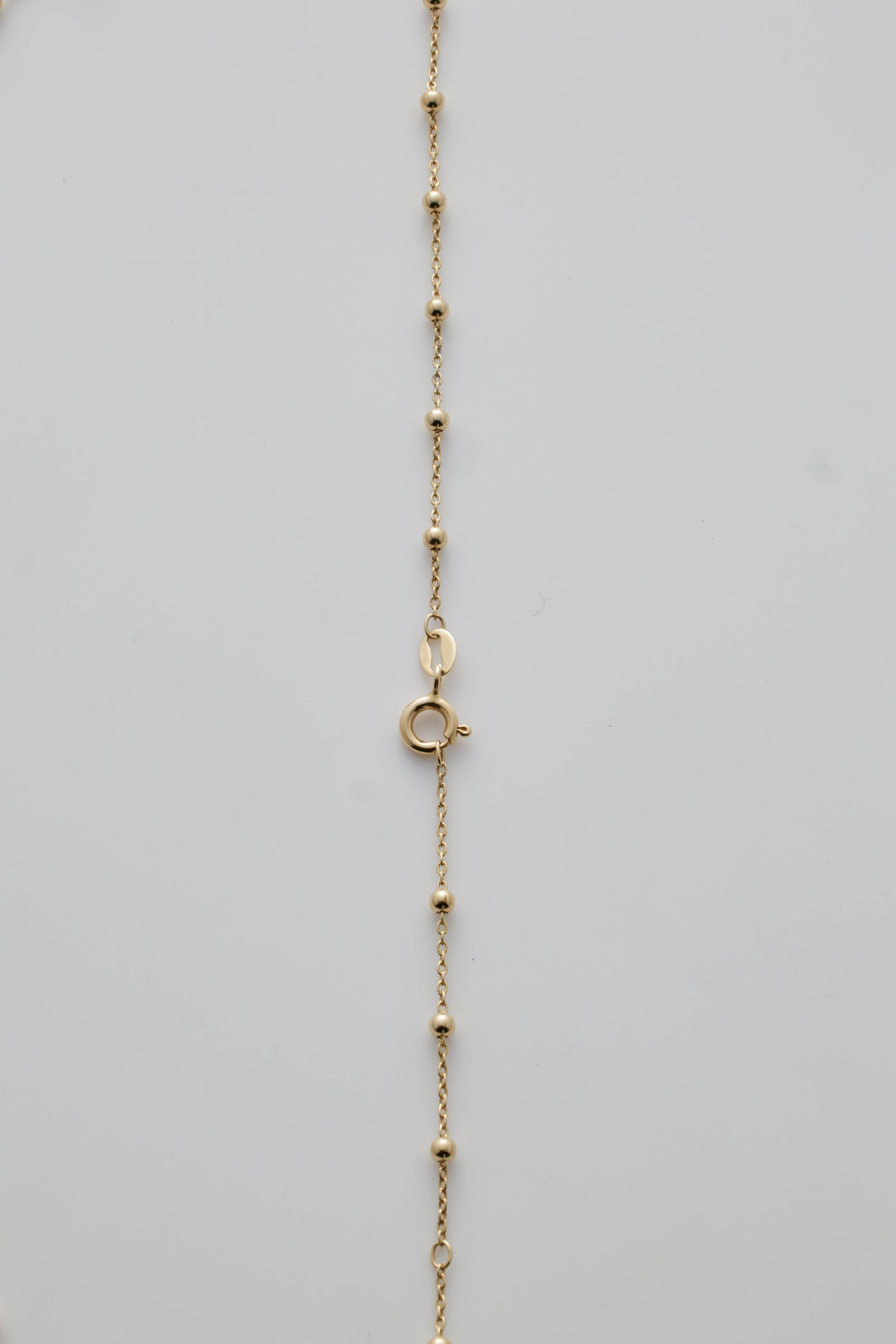 Gold necklace with spheres and clasp detail