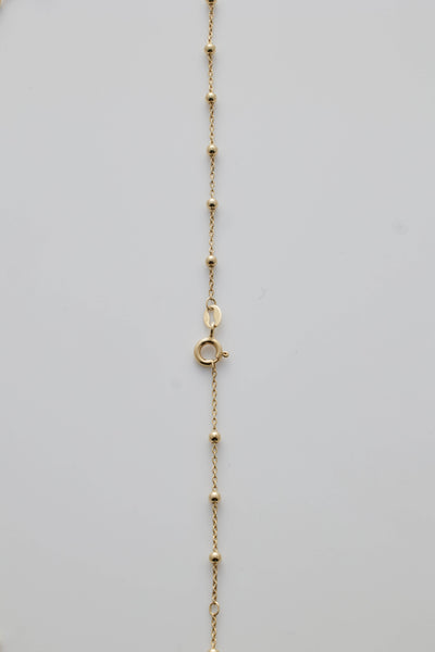Gold necklace with spheres and clasp detail