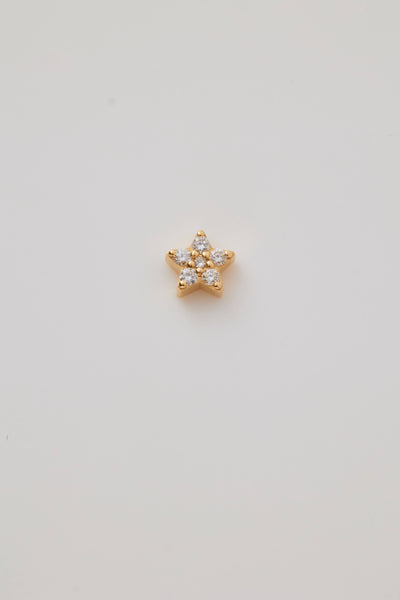 A solid gold star charm adorned with sparkling diamonds. The five-pointed star charm features brilliant-cut diamonds, creating a shimmering effect. A small hole at the top of the allows the charm to be threaded through with a necklace chain.