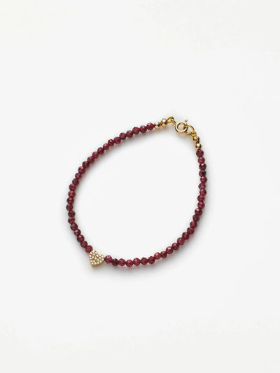 Hand-strung bracelet with garnets and miniature three-dimensional diamond heart in 18k solid gold