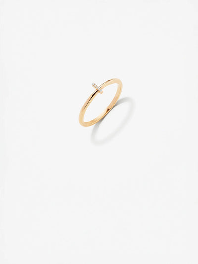 The Letter I Ring in Diamonds and 18k Gold features a slender band and a small horizontal bar adorned with tiny diamonds, set against a clean white background. The ring casts a soft shadow, emphasizing its elegant and minimalist design. Available in custom sizes for the perfect fit.