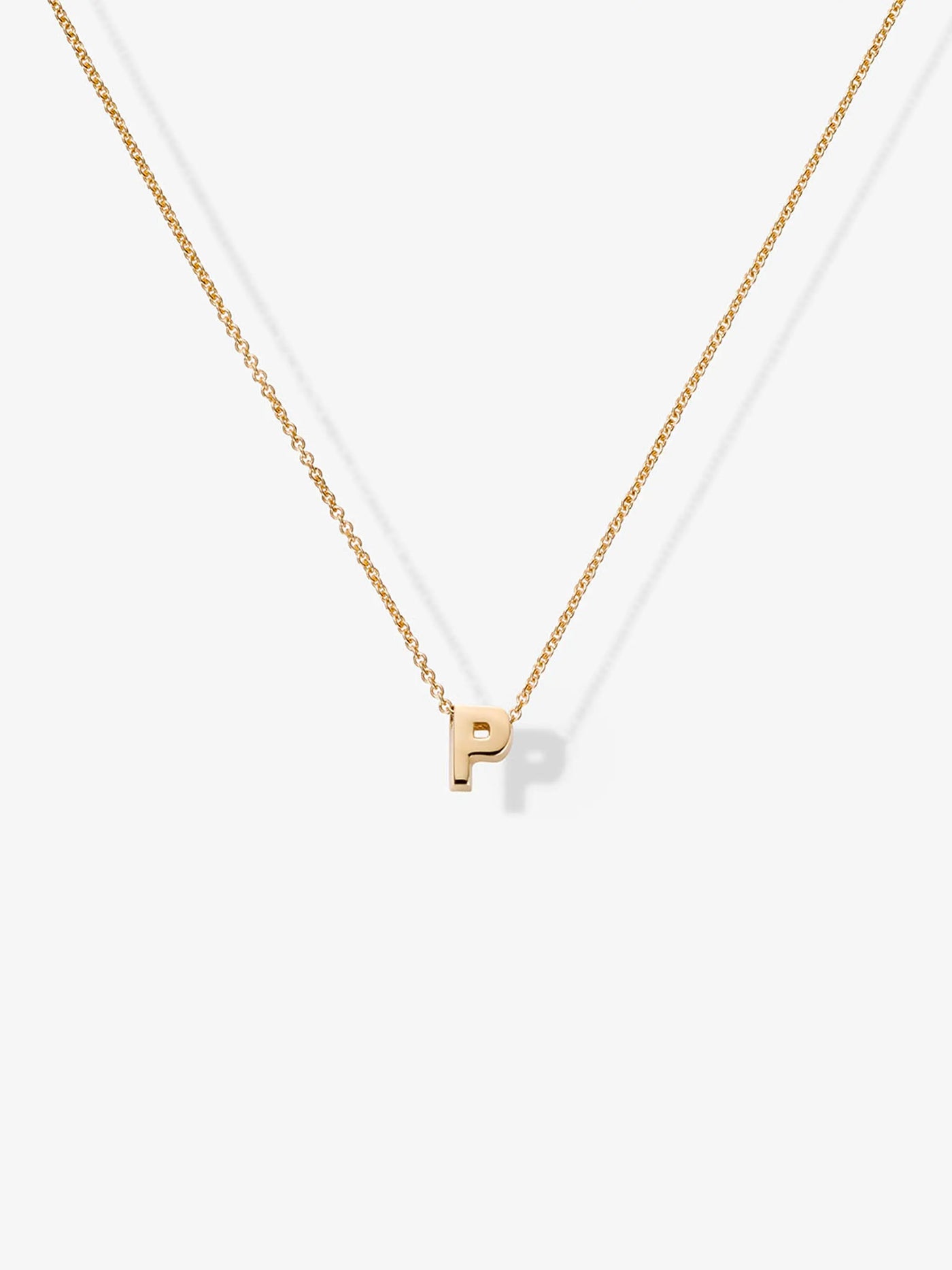 Introducing the Letter P Necklace in 18k Gold—a delicate chain adorned with a small, solid gold letter "P" pendant, beautifully presented against a plain white background.