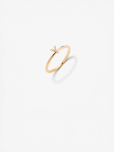 The Letter Y Ring in Diamonds and 18k Gold is an exquisite piece featuring a minimalist "Y" design at its center. Fashioned from 18k solid gold, the ring has a thin band, and the "Y" is adorned with small, round brilliant diamonds. The image is set against a white background, highlighting the ring's elegant simplicity.