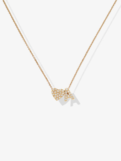 The "One Heart and Letter Necklace in Diamonds and 18k Gold" is a delicate 18k gold necklace showcasing a pendant adorned with the letters "A" and "B," each encrusted with small, sparkling diamonds. The fine gold chain allows the pendant to cast a subtle shadow against a light background.