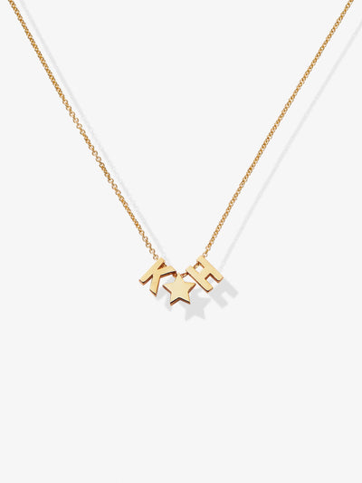 The Two Letters and Star Necklace in 18k Gold is a delicate piece featuring three charms: the letters separated by a small star, all suspended from a fine chain with an openable connector clasp. The plain white background highlights the simplicity and elegance of this exquisite necklace.