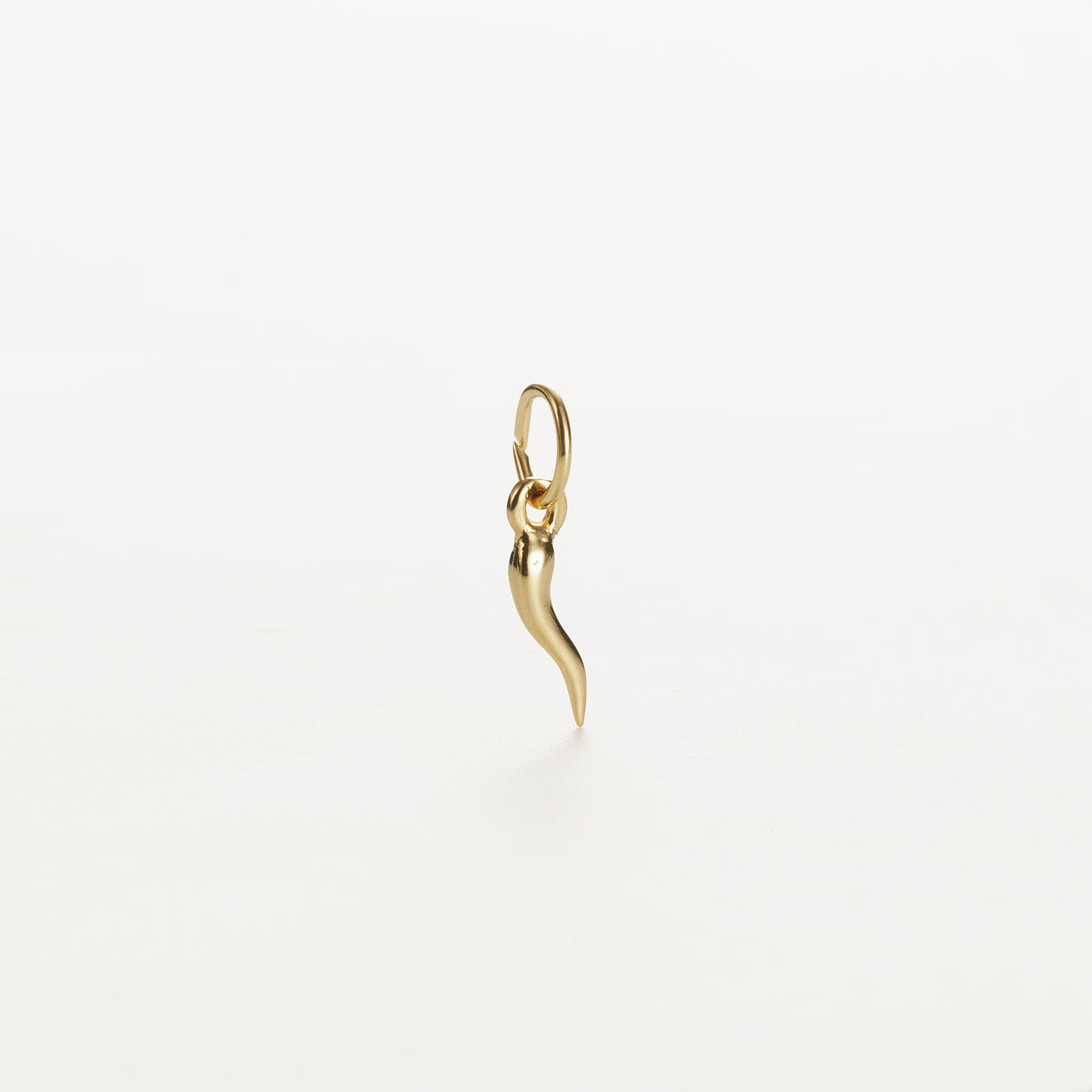 A small 9k gold earring featuring the "Small Horn of Plenty Charm" dangles elegantly from an oval loop. Set against a plain white background, this piece exudes understated simplicity.