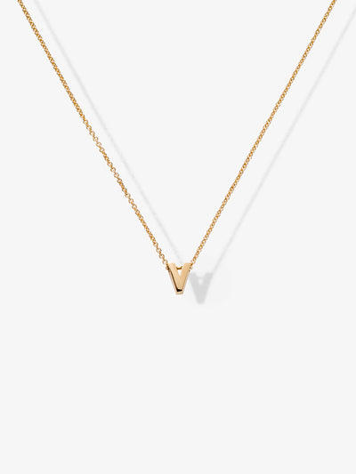 Introducing the Letter V Necklace in 18k Gold: a delicate and minimalist 'V' pendant on a fine gold chain. Set against a plain white background, this elegant piece truly showcases the sophistication and simplicity of the design.