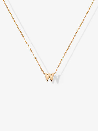 The Letter W Necklace in 18k Gold showcases a delicate small "W" pendant hanging from a fine chain. The centered pendant stands out against a plain white background, highlighting the elegance of personalized jewelry.