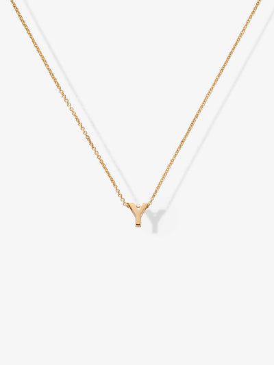 A delicate Letter Y Necklace in 18k Gold, featuring a small gold letter "Y" pendant gracefully hanging from a fine 18k solid gold chain. The necklace is elegantly displayed against a plain white background.