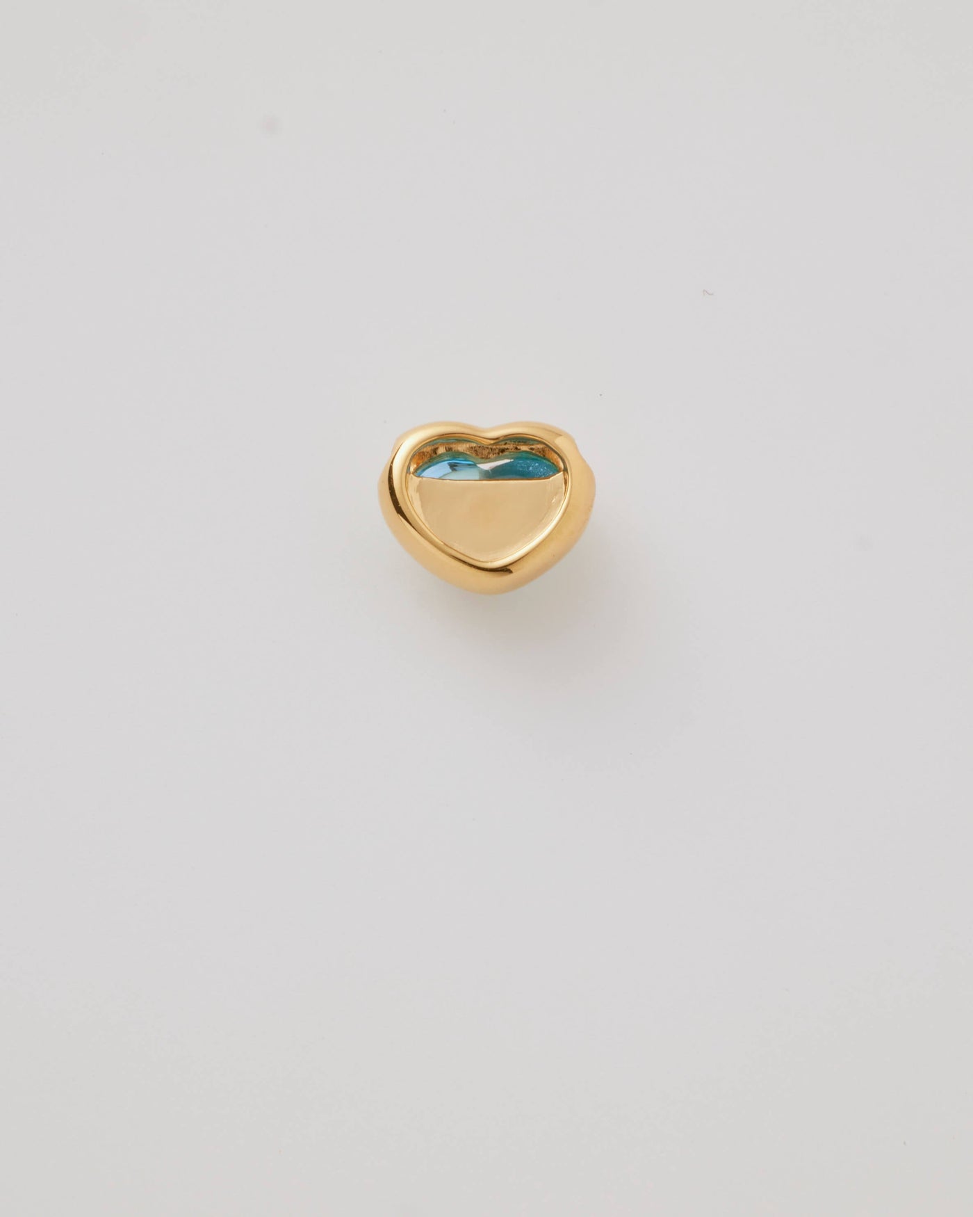 Small solid gold heart charm with a blue cabochon stone, designed to slide onto a necklace chain for a personalised jewellery piece.