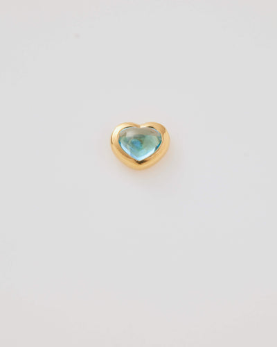 Small solid gold heart charm with a blue cabochon stone, designed to slide onto a necklace chain for a personalised jewellery piece.