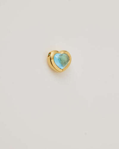 Small solid gold heart charm with a blue cabochon stone, designed to slide onto a necklace chain for a personalised jewellery piece.