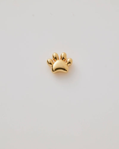 Small solid gold cat paw charm, designed to slide onto a necklace chain for a personalised jewellery piece.