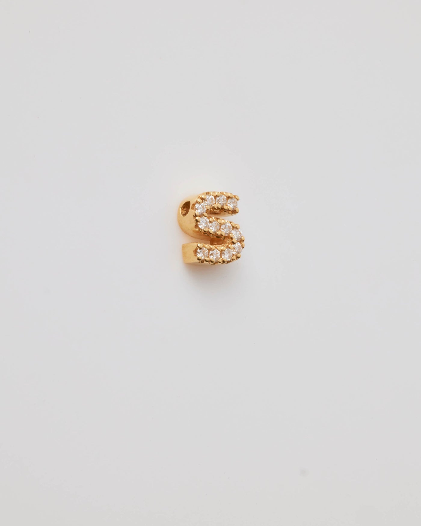 Small solid gold three-dimensional letter 'S' charm with pavé set diamonds, designed to thread onto a necklace chain.