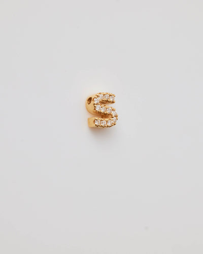 Small solid gold three-dimensional letter 'S' charm with pavé set diamonds, designed to thread onto a necklace chain.