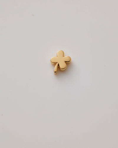 Solid gold four-leaf clover charm representing luck, hope, faith, and love, designed to slide onto a necklace chain for a timeless keepsake.