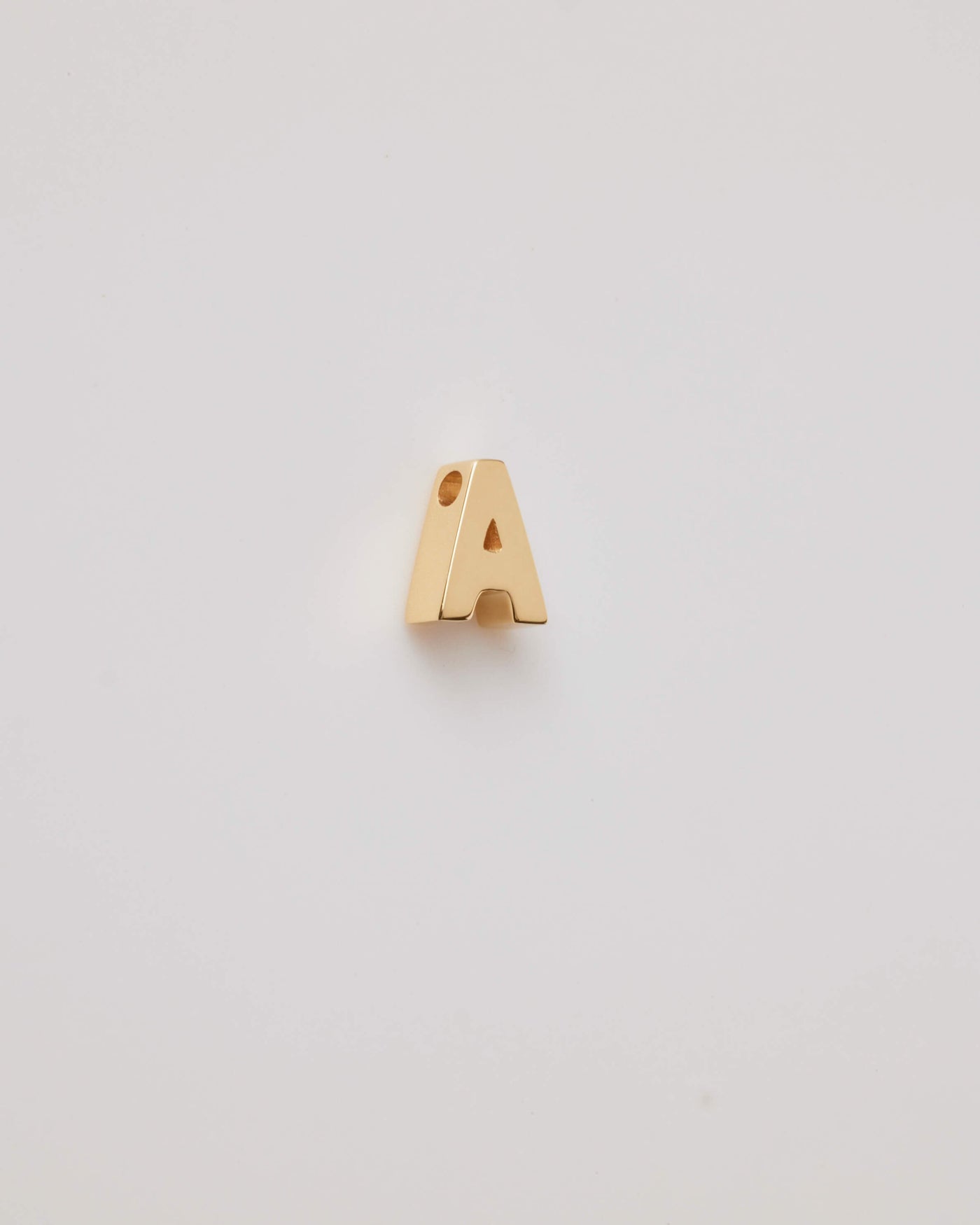 Small gold polished three-dimensional letter 'A' charm with a smooth finish, designed to thread onto a necklace chain.