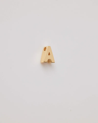 Small gold polished three-dimensional letter 'A' charm with a smooth finish, designed to thread onto a necklace chain.