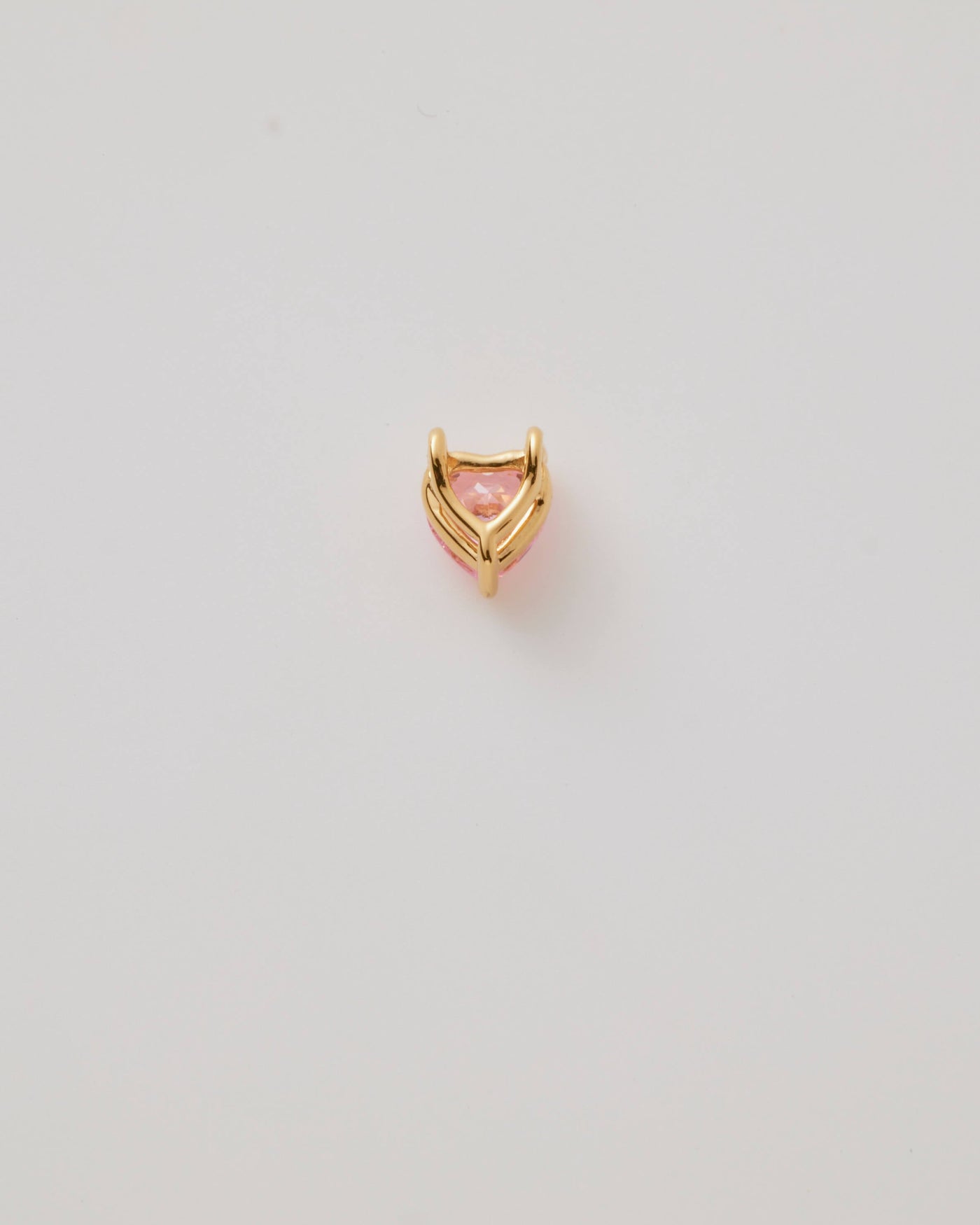 Small solid gold pink heart charm, designed to slide onto a necklace chain for a personalised jewellery piece.