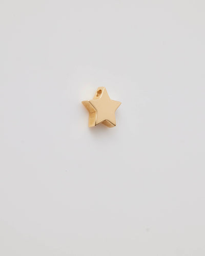 Polished solid gold star charm, a symbol of remembrance and love.