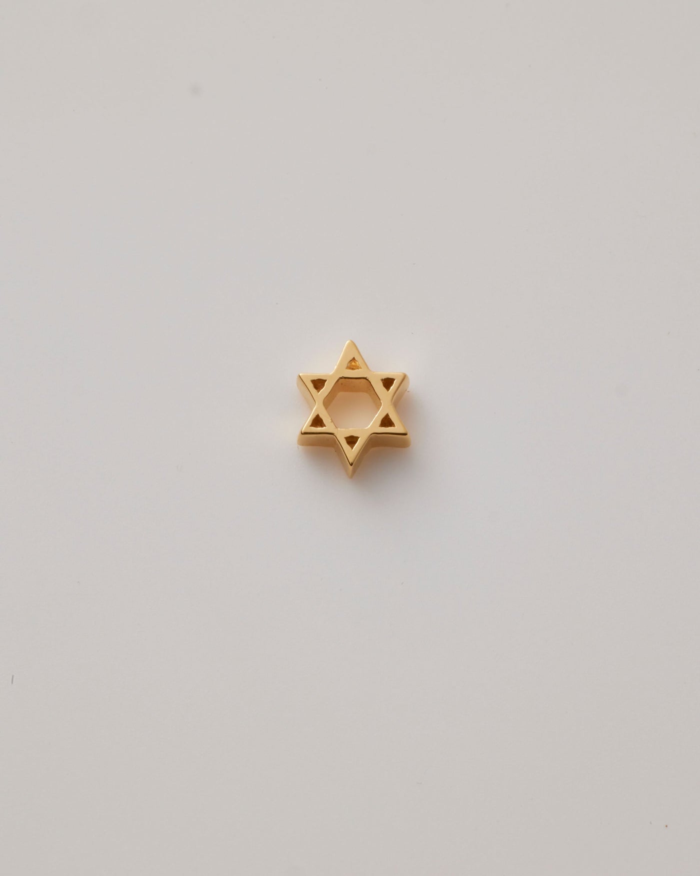 Small solid gold Star of David charm, designed to slide onto a necklace chain for a personalised jewellery piece.