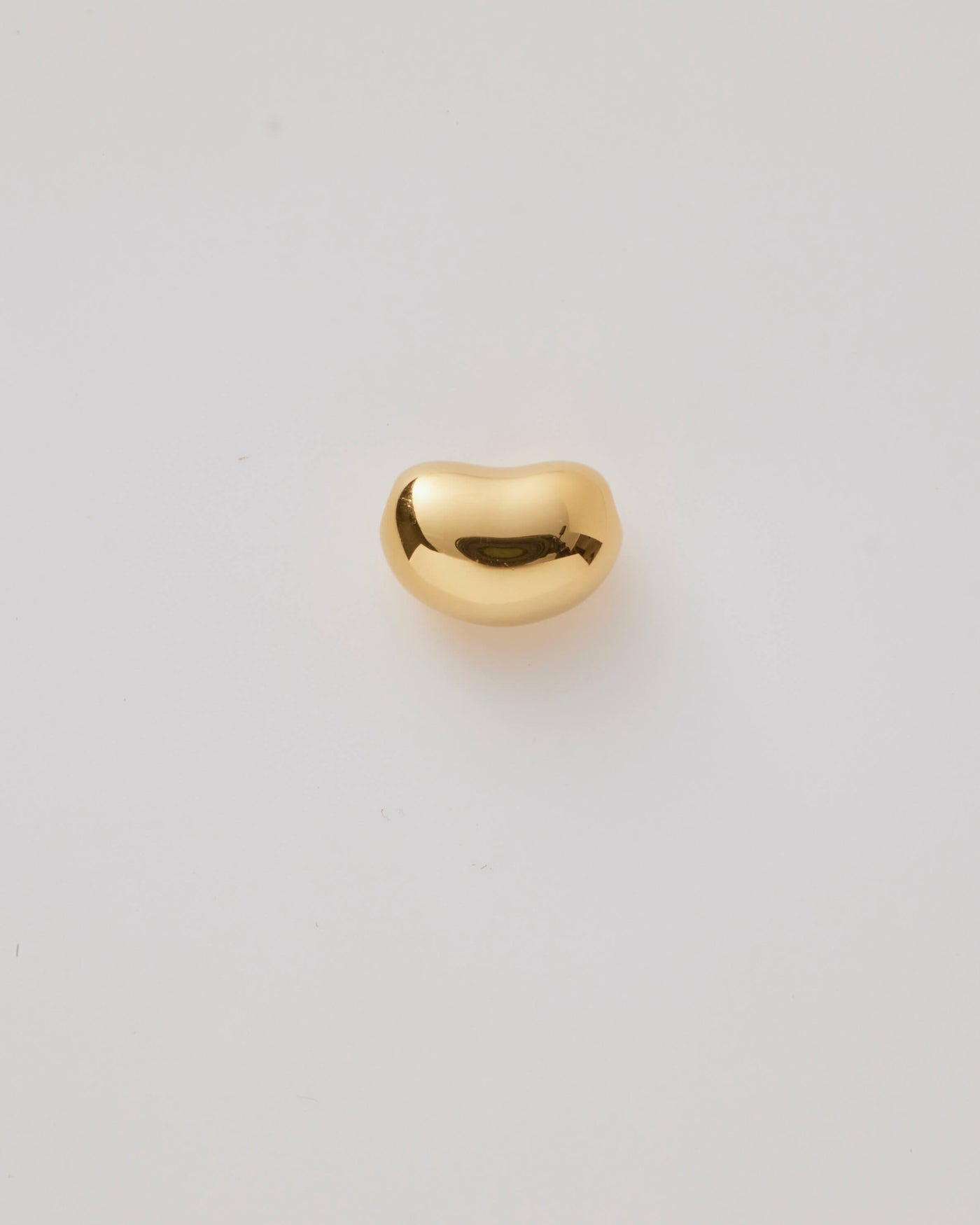 Small solid gold bean charm with a smooth organic shape, symbolising growth, renewal, and infinite possibilities