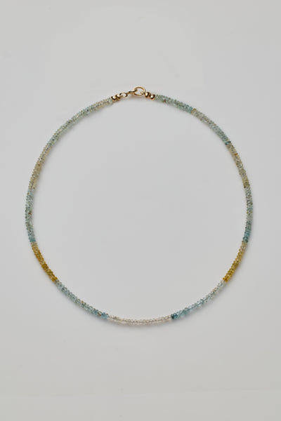 Faceted aquamarine beaded collier necklace with gold clasp on silk