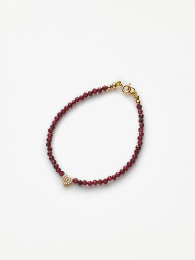 Hand-strung bracelet with garnets and miniature three-dimensional diamond heart in 18k solid gold