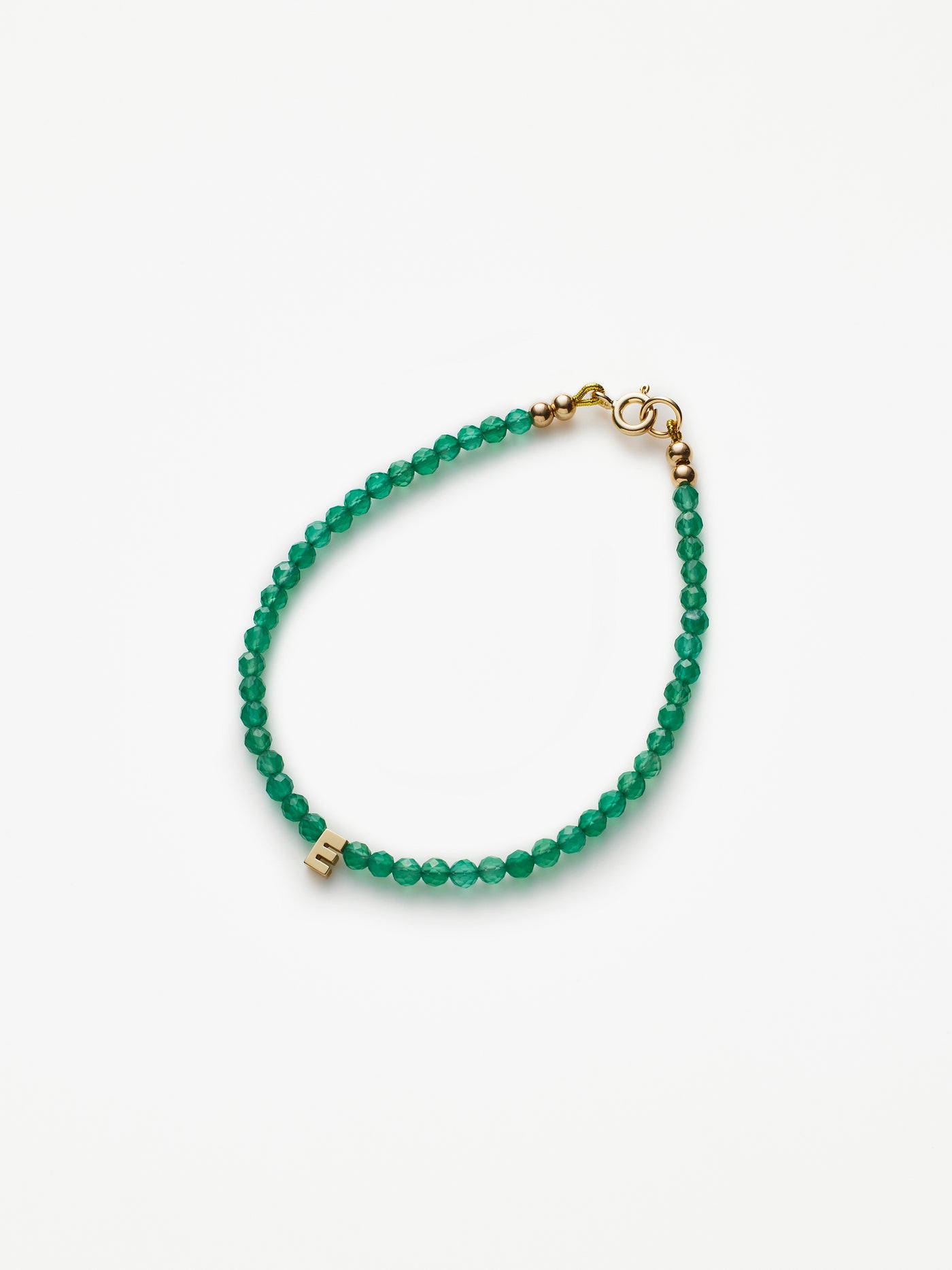 Hand-strung bracelet with natural green onyx gemstones and miniature three-dimensional letter in 18k solid gold