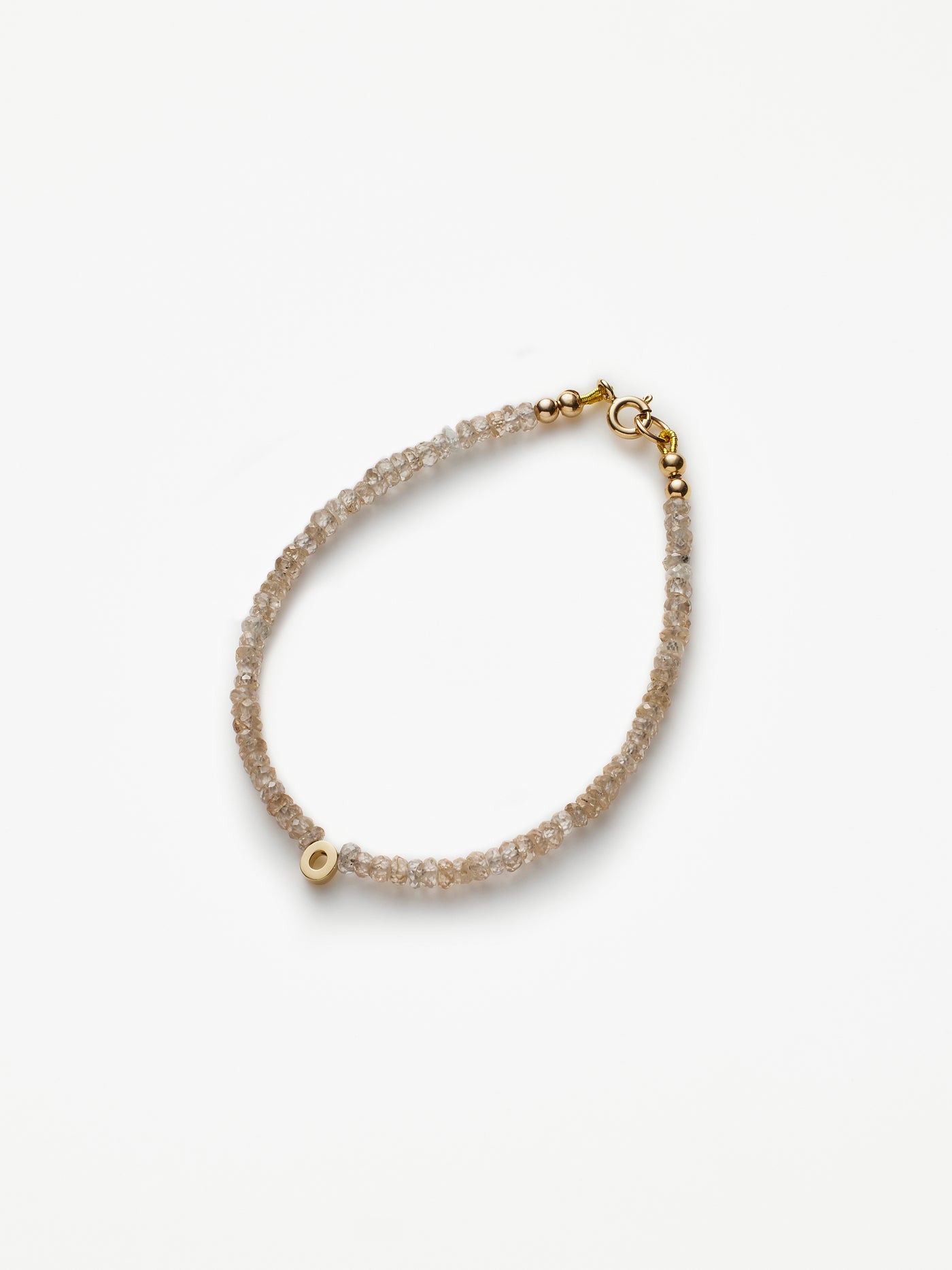 Hand-strung bracelet with natural natural zircon gemstones and miniature three-dimensional letter in 18k solid gold