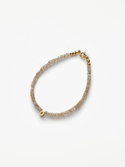 Hand-strung bracelet with natural natural zircon gemstones and miniature three-dimensional letter in 18k solid gold