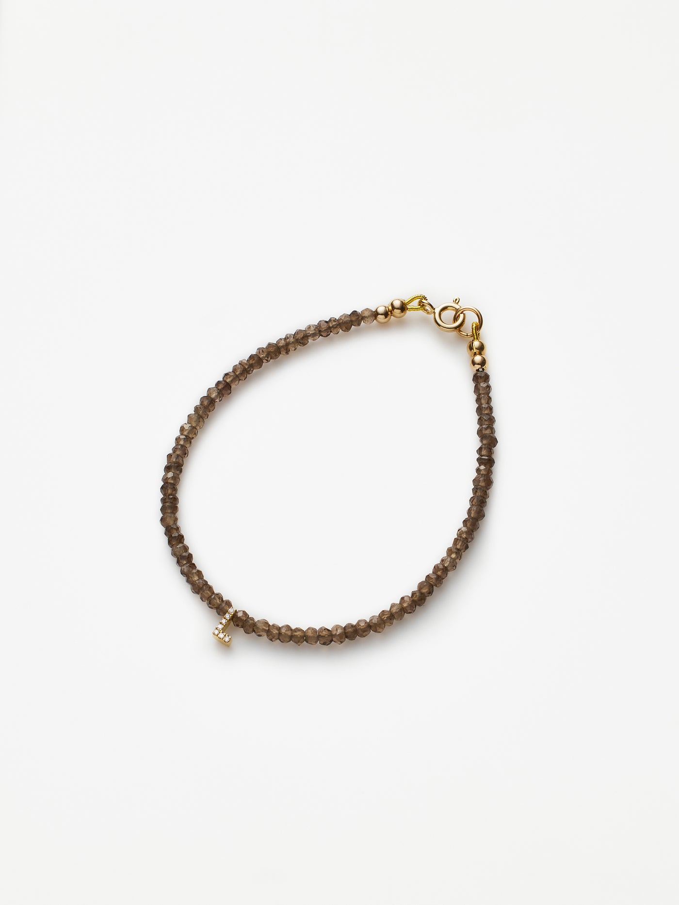 Hand-strung bracelet with natural smoky quartz gemstones and miniature three-dimensional diamond letter in 18k solid gold