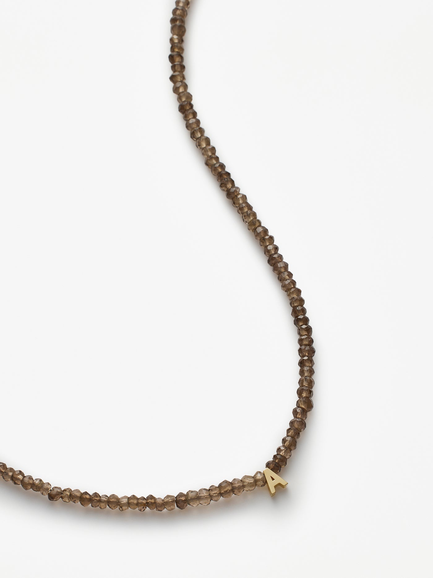 Hand-strung necklace with natural, faceted smoky quartz gemstones and miniature three-dimensional letter in 18k solid gold