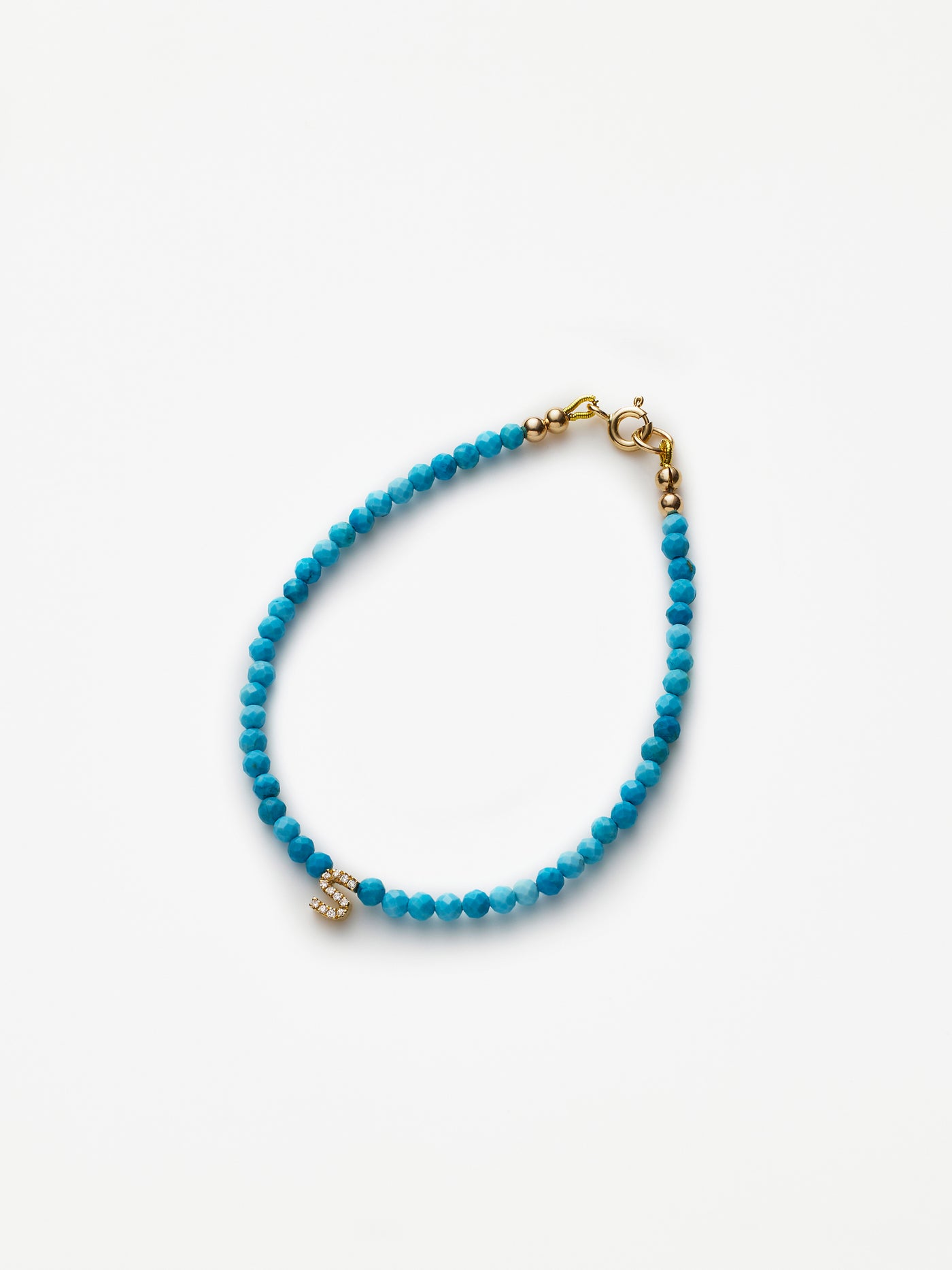 Hand-strung bracelet with natural, faceted turquoise gemstones and miniature three-dimensional diamond letter in 18k solid gold